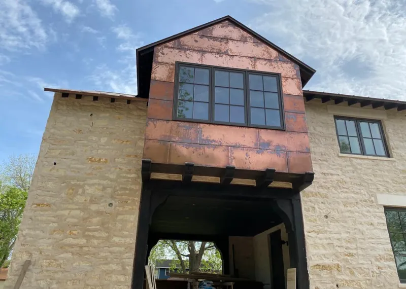 Copper metal panel facade on a stone building for Metal Roof Coating in Loudon
